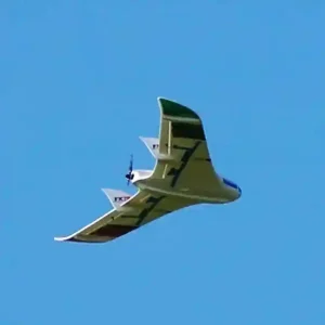 A drone, seen from below, flies through a cloudless blue sky.